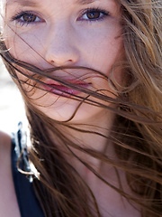 Beach girl plays in the ocean after she strips nude, her supple form getting excited by the breaze.