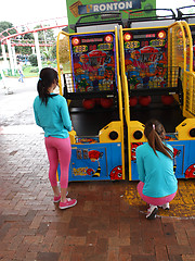 Two latina girls in tight pink leggings have fun in the park