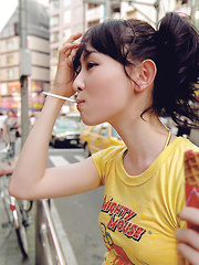 Rina Akiyama Asian with sexy lips rubs her cunt of bar outdoor